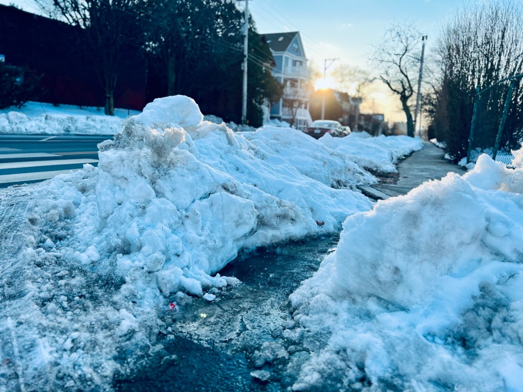 A path is cut into piles of snow.