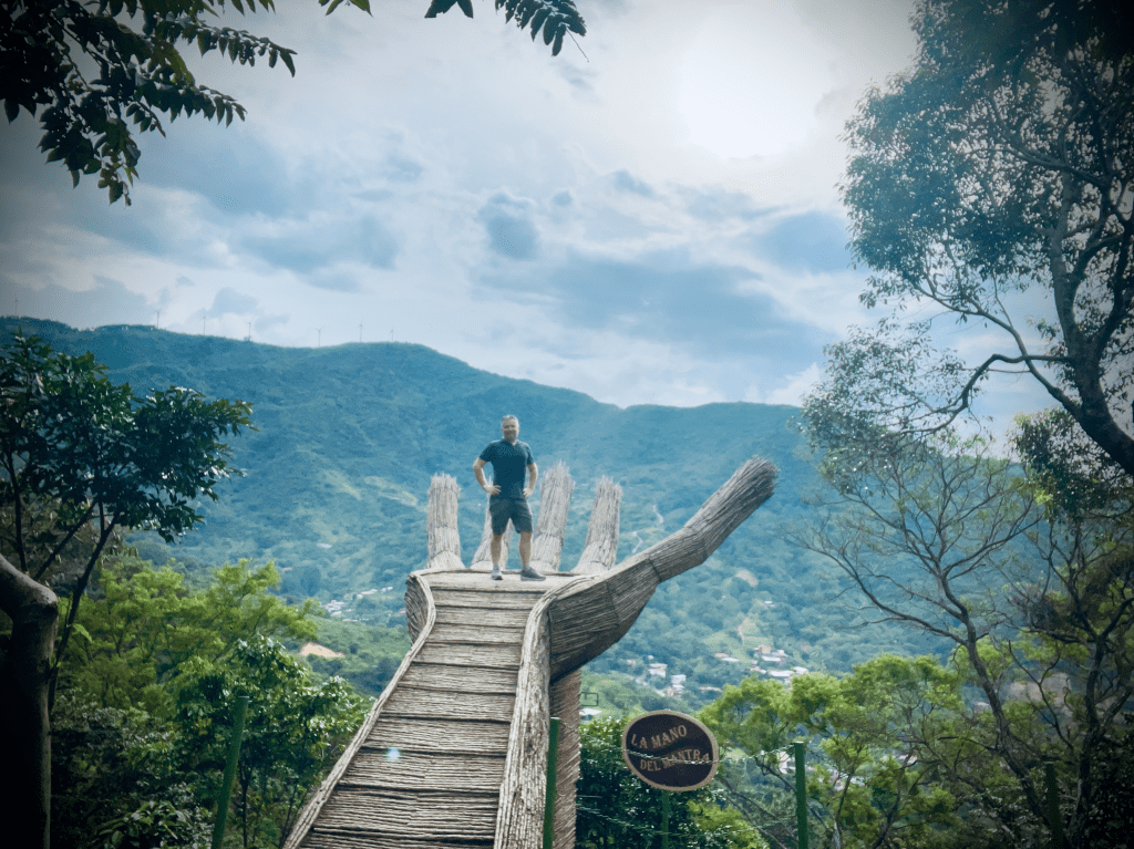 A sculpture of a giant wicker hand stretches over a tropical valley in Costa Rica.