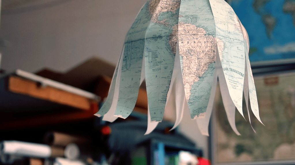 A globe made of paper strips hangs from the ceiling of The Map Center